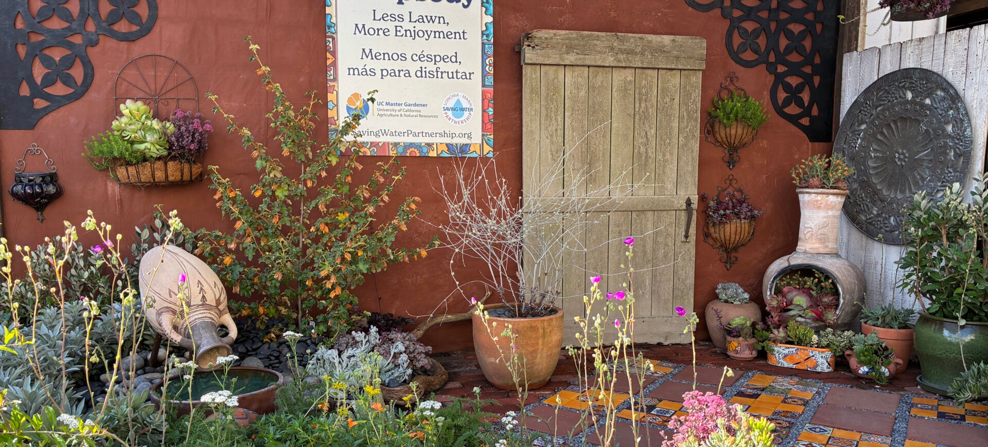 Photo of the 2026 Sonoma County fair display titled Botanical Rhapsody featuring a Spanish themed tiled patio surrounded with low-water use plants.